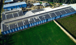 Rooftop solar power plant with rows of photovoltaic panels - Konifer